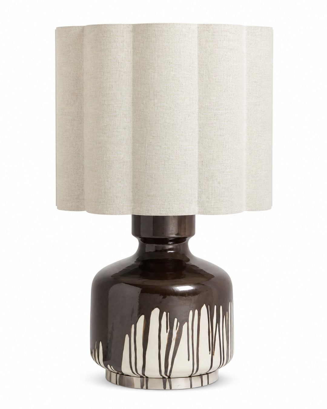Table lamp with a dark chocolate drip-glazed ceramic base and a scalloped linen shade