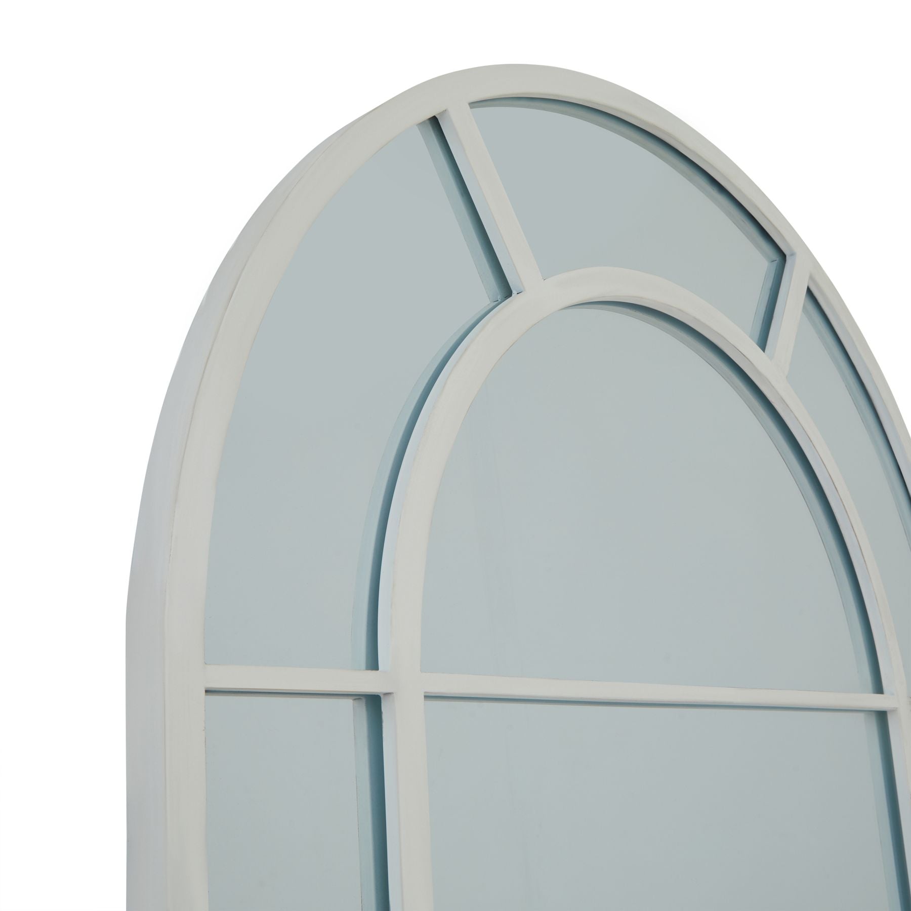 Arched window mirror styled in a hallway