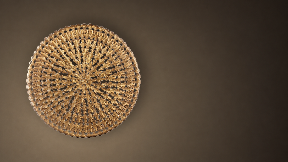 Cast bronze round wall panel on warm plaster — Sculpture for the Wall
