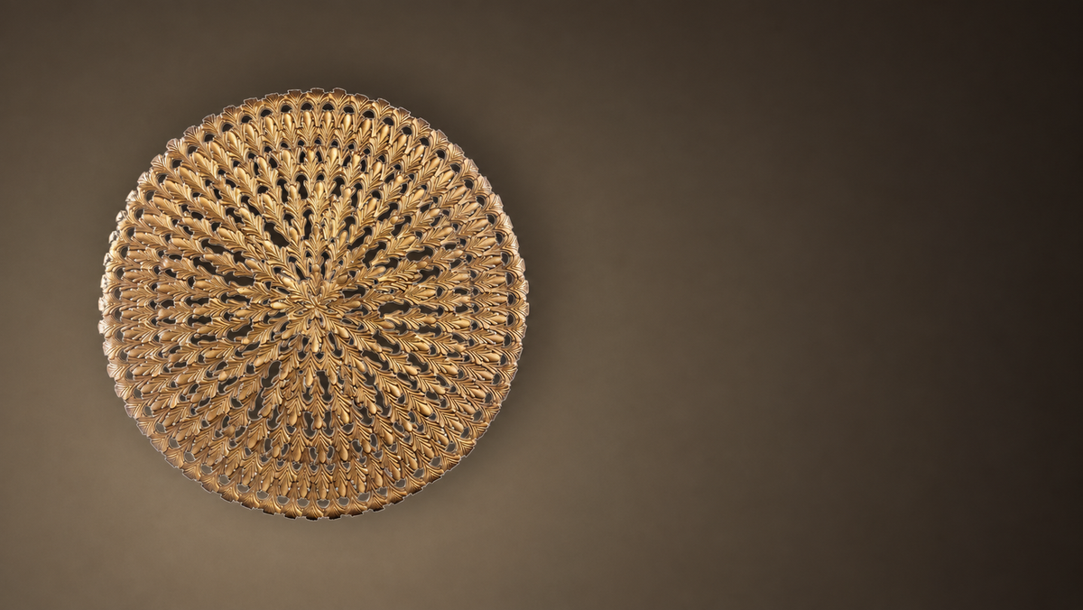 Cast bronze round wall panel on warm plaster — Sculpture for the Wall