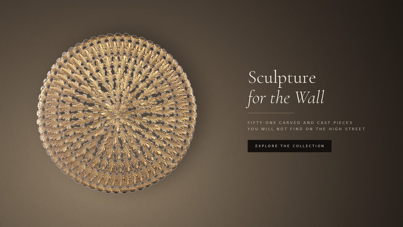Cast bronze round wall panel on warm plaster — Sculpture for the Wall