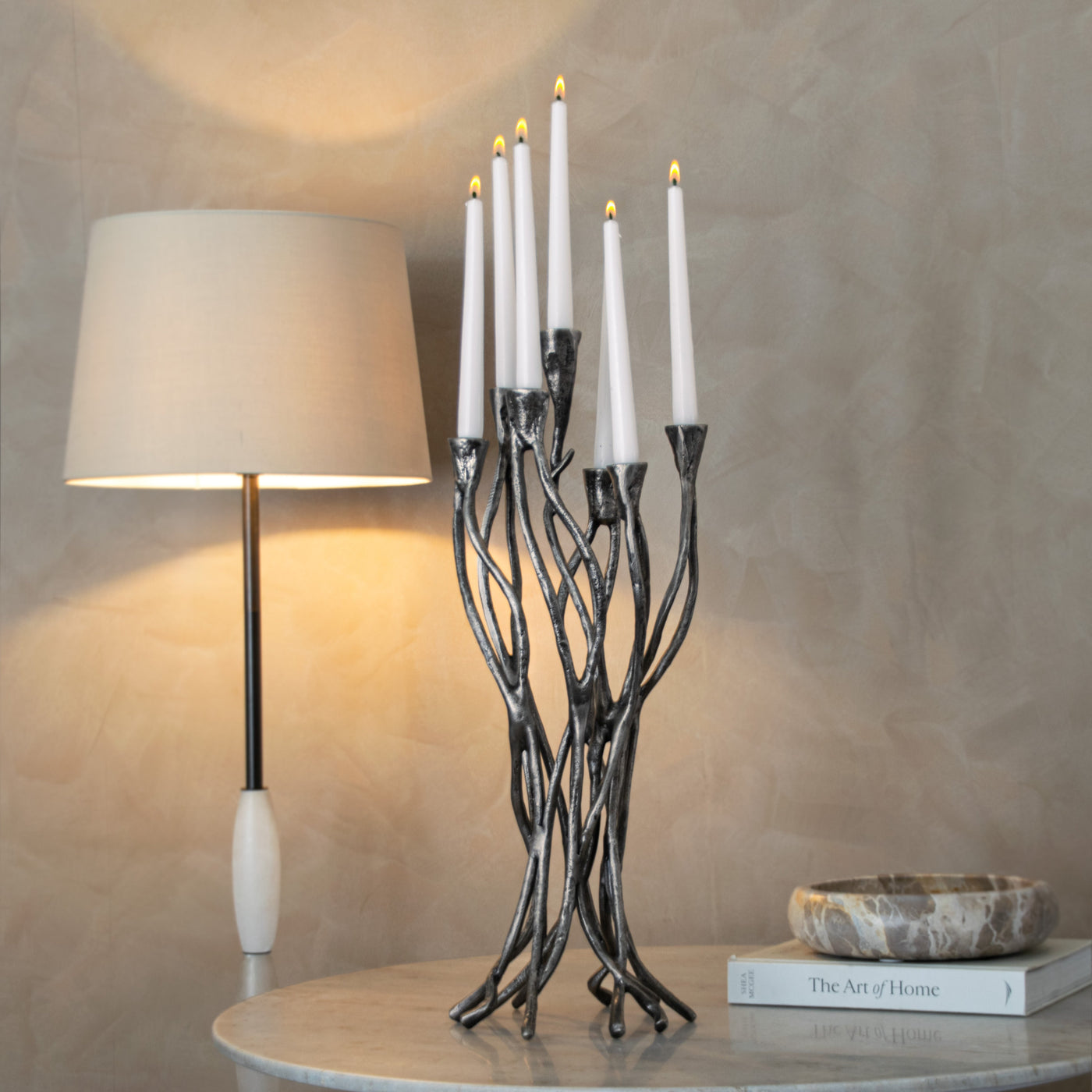 Sculptural candelabra with lit candles — Conpanna Living