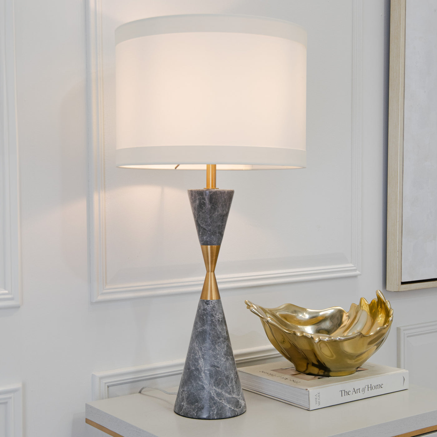 Marble and brass table lamp on a console — Conpanna Living