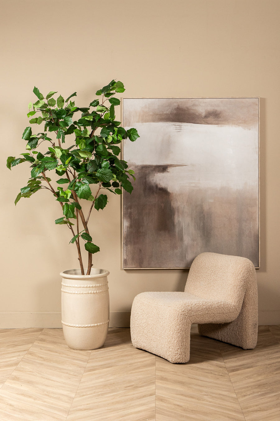 Faux grape leaf tree in weighted pot