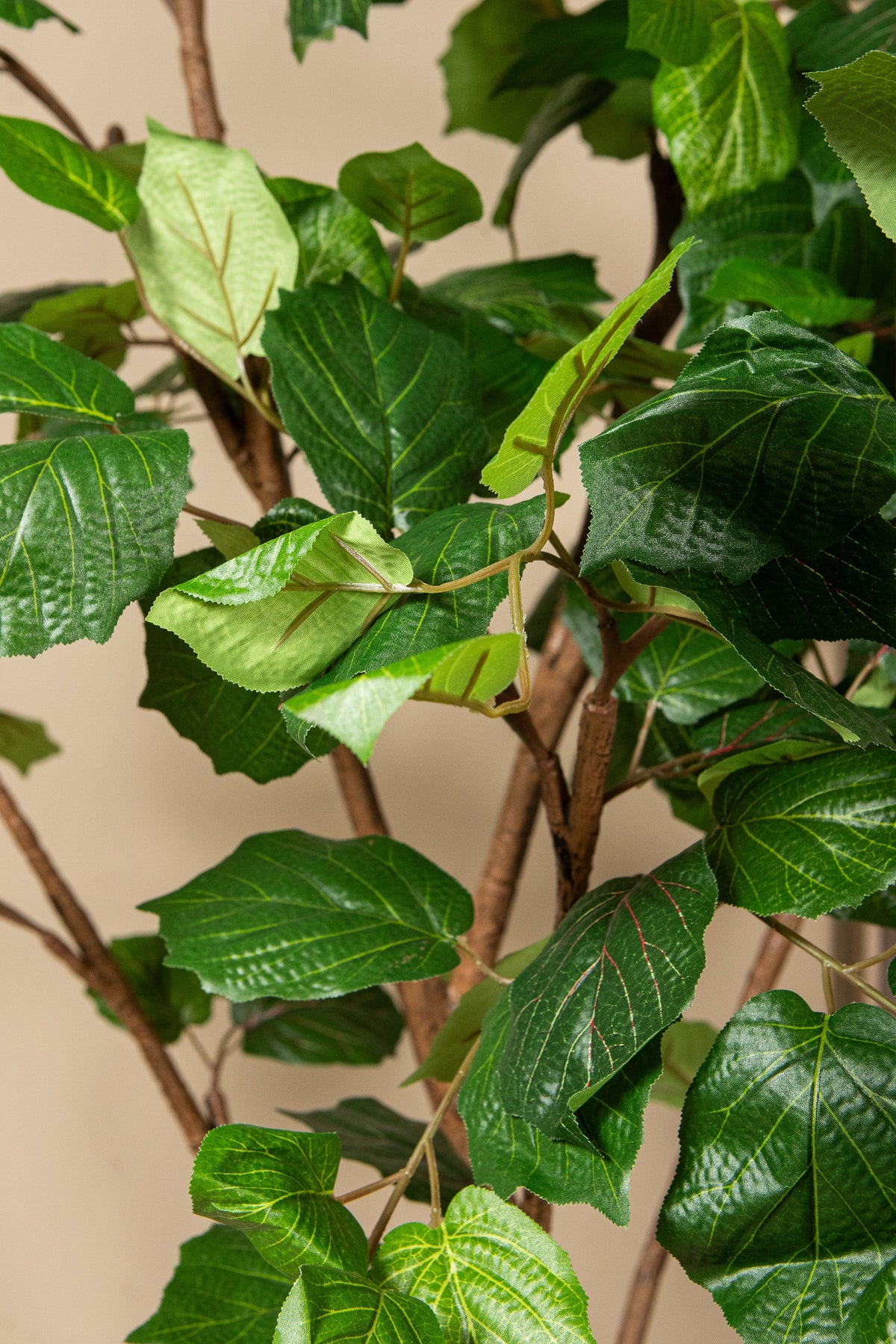 Faux grape leaf tree in weighted pot