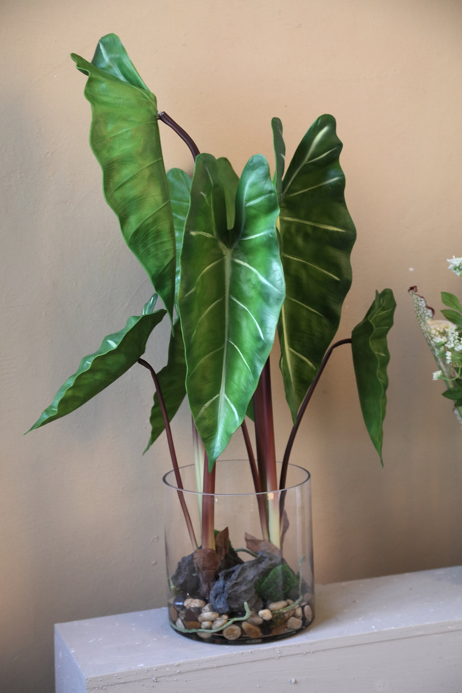 Leaves faux green plant in a glass vase