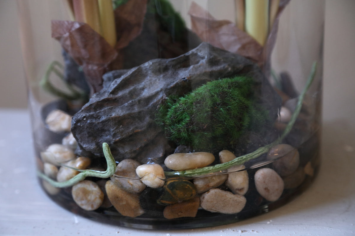 Leaves faux green plant in a glass vase