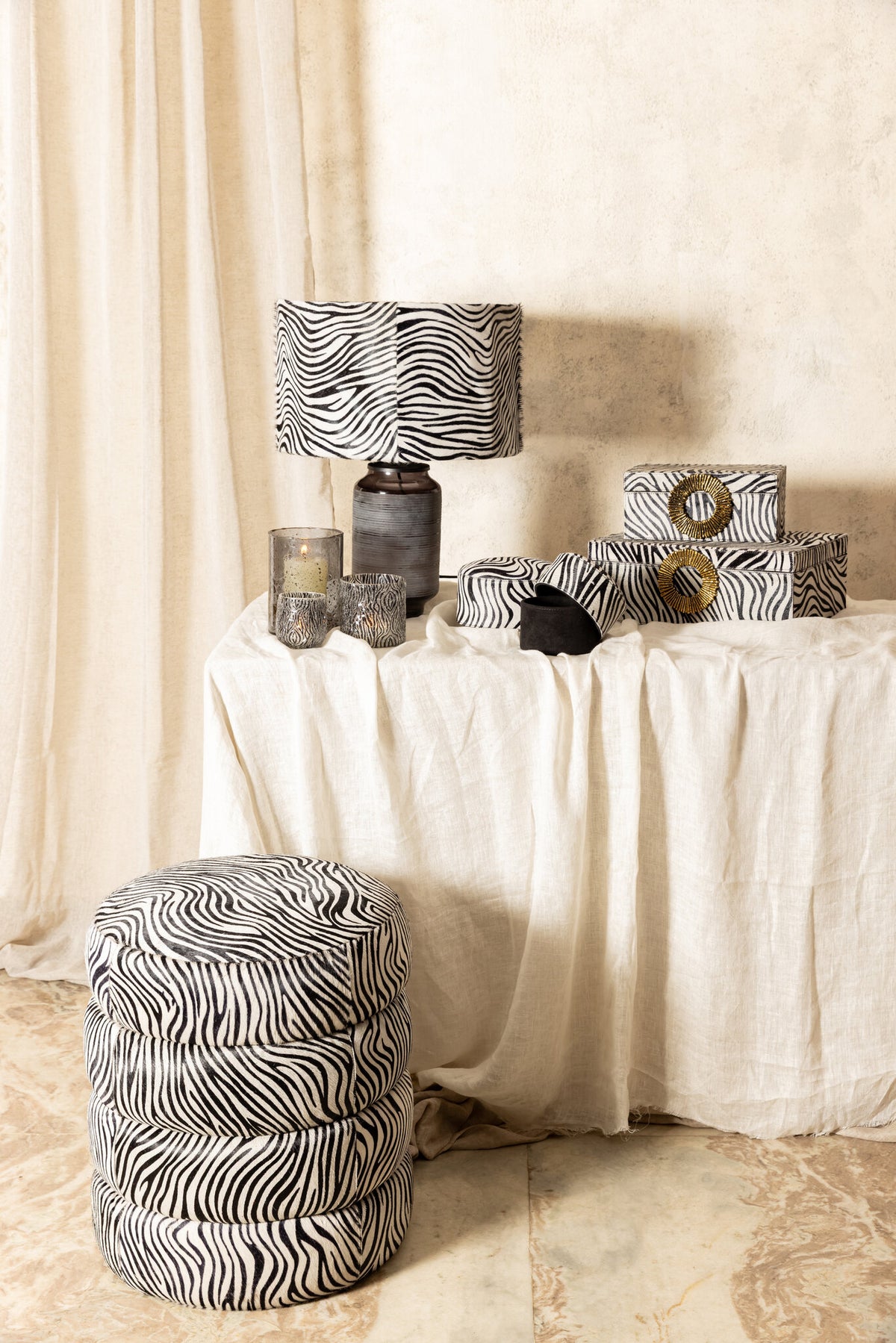 Royan black zebra-pattern cowhide storage pouffe, round