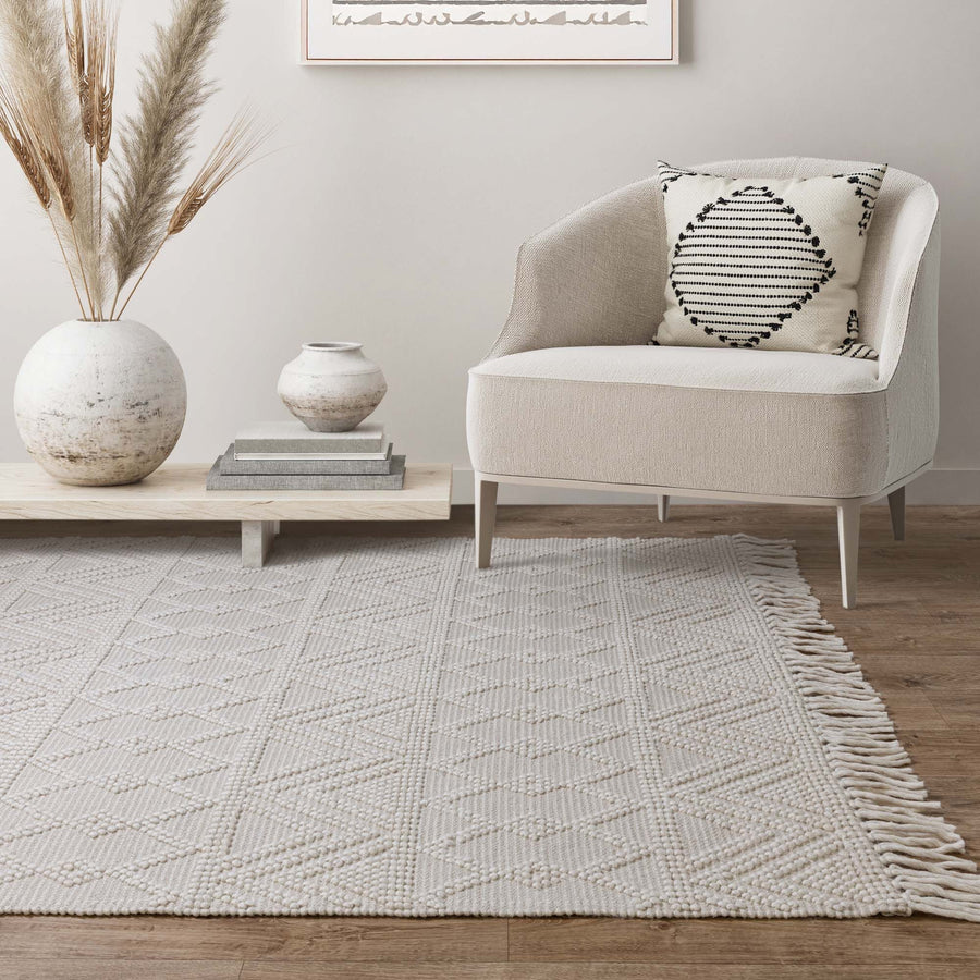 Asra Ivory hand-woven wool flatweave rug on a white background