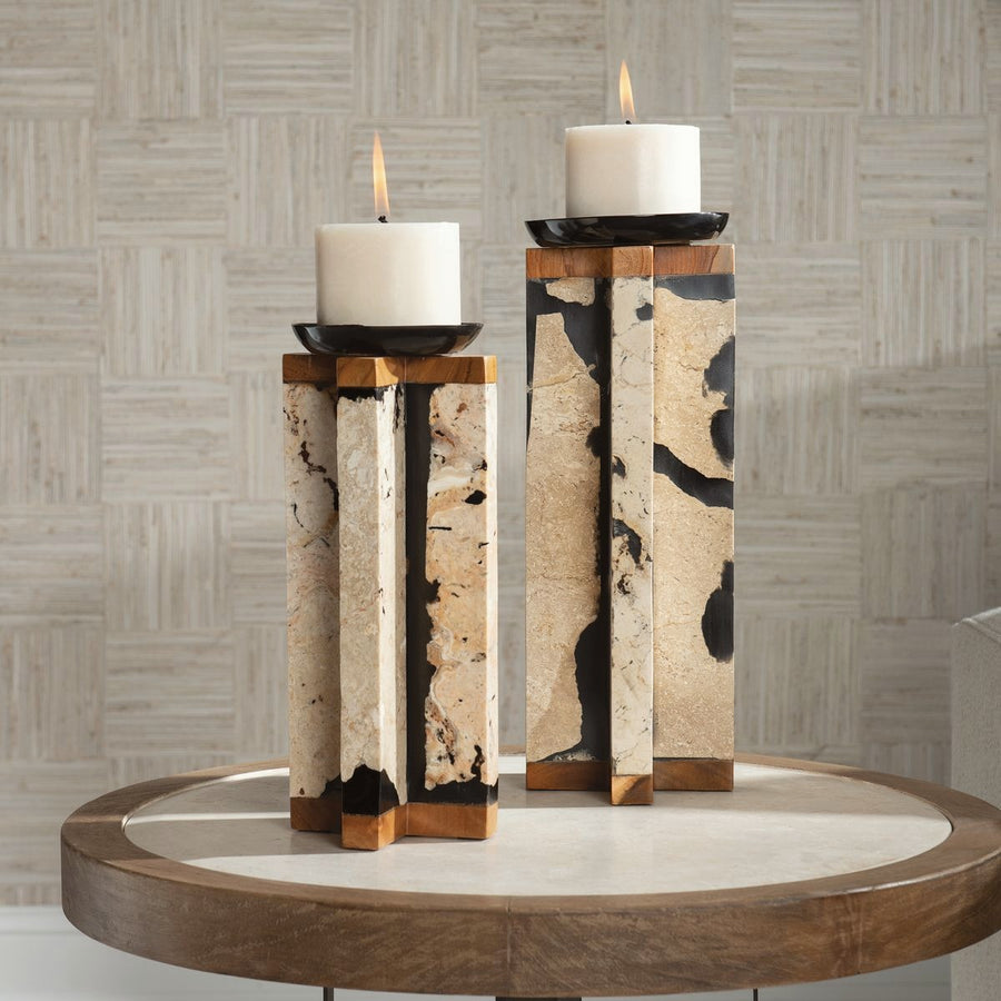 Sculptural candle holders styled on a round side table