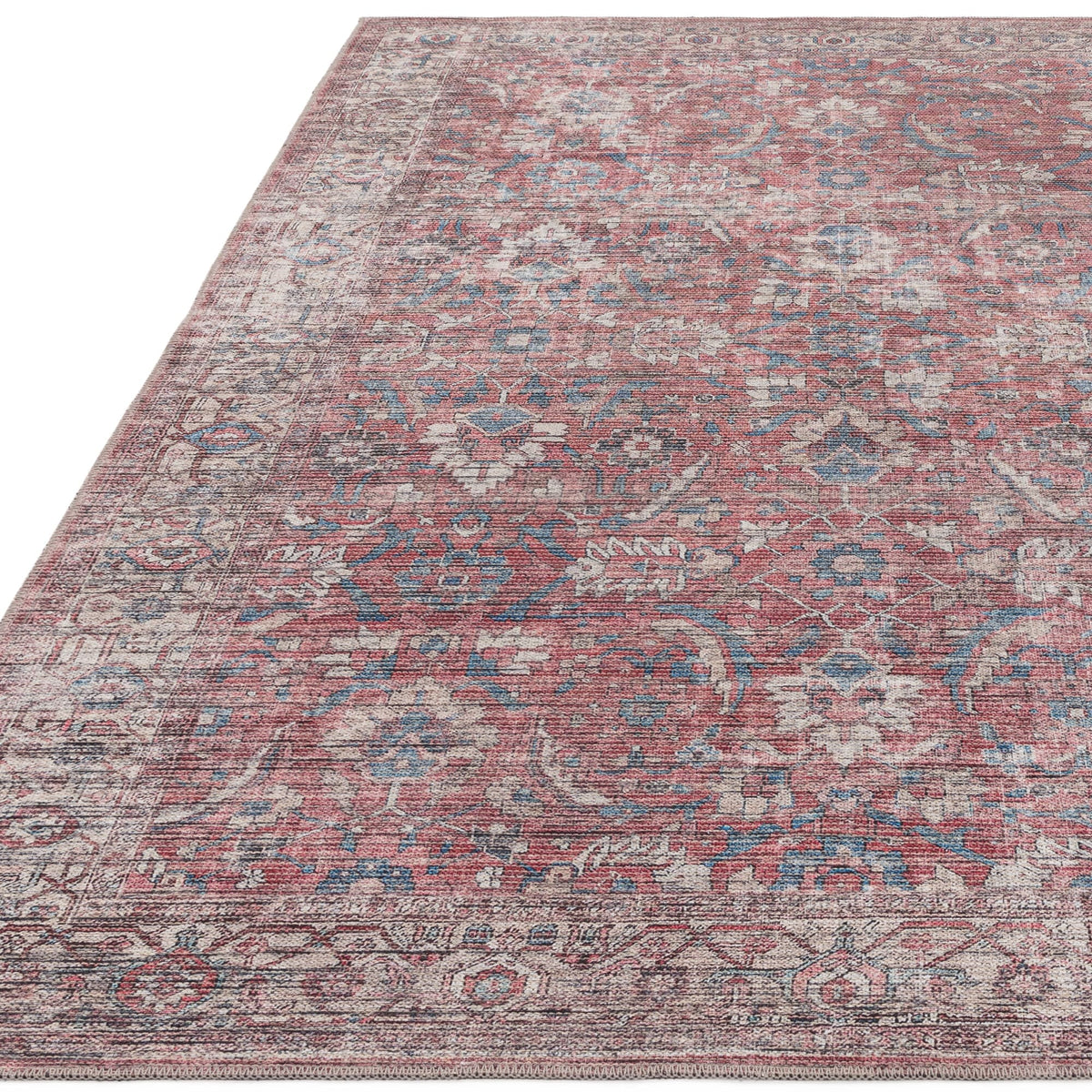 Kaya Mona washable flatweave rug with faded floral pattern on white background