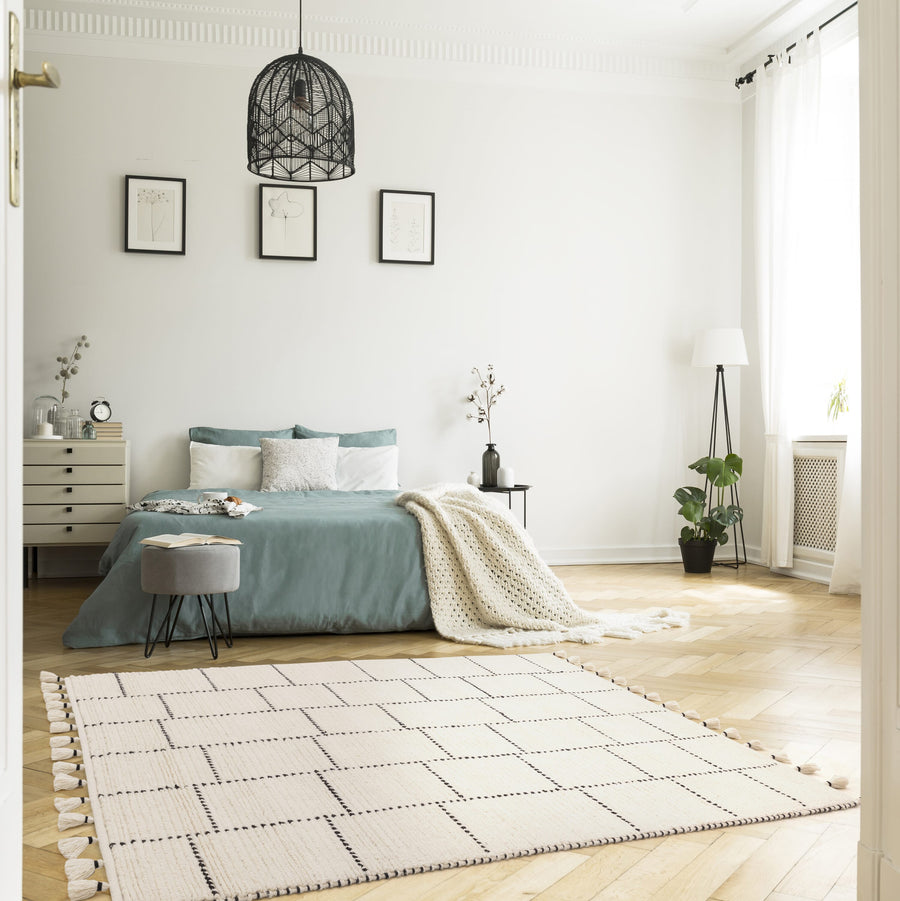 Nepal Cream Black Tile wool rug on plain background
